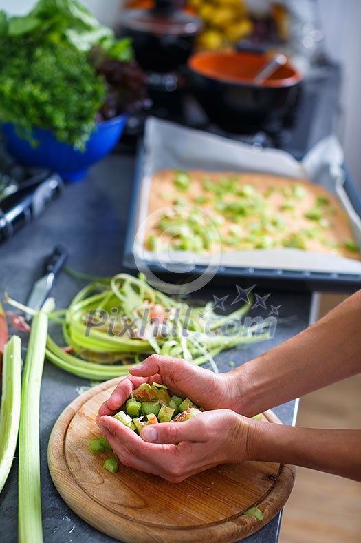 Young woman cooking in her modern kitchen (shallow DOF; color toned image)