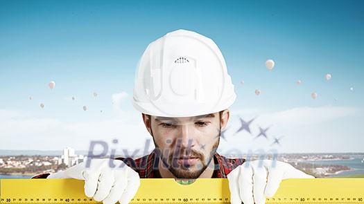 Builder man in checked shirt using measuring level Builder man in checked shirt using measuring level