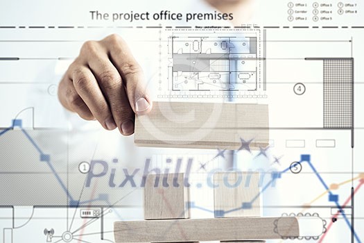 Close view of businessman making pyramid with empty wooden cubes