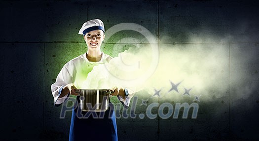 Pretty woman cook in hat and apron with pot in hands Pretty woman cook in hat and apron with pot in hands