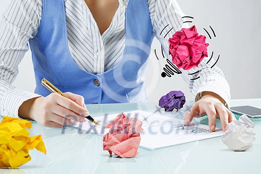 Close view of businesswoman sitting at desk in search of good idea Close view of businesswoman sitting at desk in search of good idea