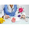 Close view of businesswoman sitting at desk in search of good idea