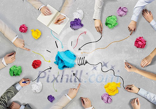 Top view of business people working together while sitting at table Top view of business people working together while sitting at table