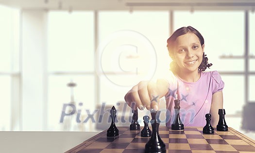Young caucasian kid girl playing game of chess Young caucasian kid girl playing game of chess
