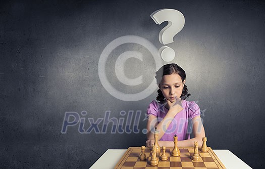 Young caucasian kid girl playing game of chess Young caucasian kid girl playing game of chess
