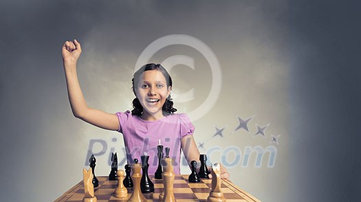 Young caucasian kid girl playing game of chess Young caucasian kid girl playing game of chess