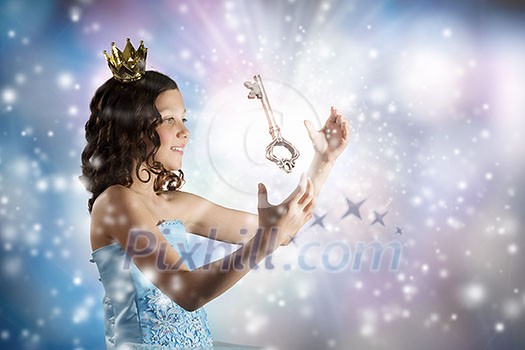 Little girl princess in blue dress with diadem on head