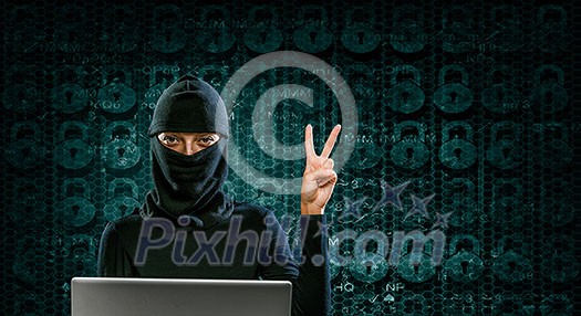Hacker woman in dark clothes using laptop against digital background