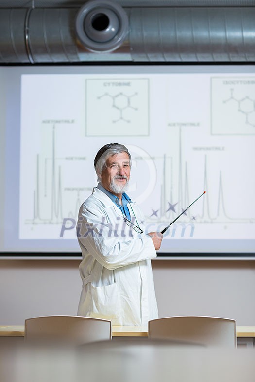 Senior chemistry professor giving a lecture in front of classroom full of students (shallow DOF; color toned image)