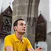 Handsome young man praying in a church