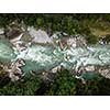 Aerial top view of a splendid whitewater on a mountain river in Swiss Alps