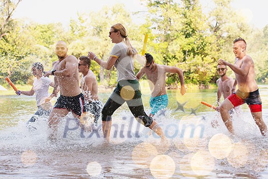 summer joy group of happy friends having  fun while running and splashing on river