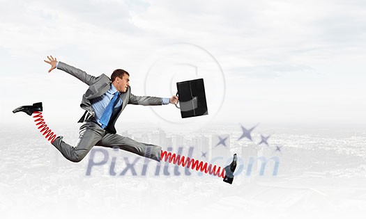 Businessman in suit running with big springs on feet Businessman in suit running with big springs on feet