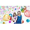 Two young woman in casual with colorful balloons celebrating