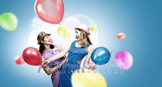Two young woman in casual with colorful balloons celebrating Two young woman in casual with colorful balloons celebrating