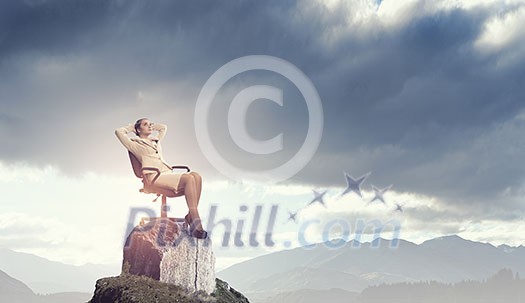 Young relaxed businesswoman sitting relaxed in chair and dreaming Young relaxed businesswoman sitting relaxed in chair and dreaming