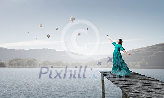 Elegant woman in green long dress outdoors Elegant woman in green long dress outdoors