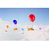 Concept of surrealism with gold fish flying on air balloon
