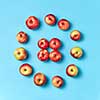 Fresh natural vegan apples pattern on a blue background with copy space. Concept of organic eating. Top view.