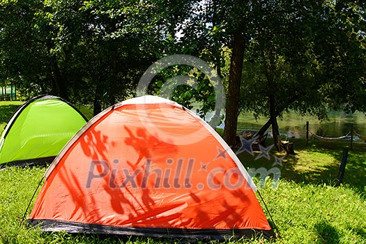 calm relaxing camp tent near the beautiful river on sunny summer day calm relaxing camp tent near the beautiful river on sunny summer day