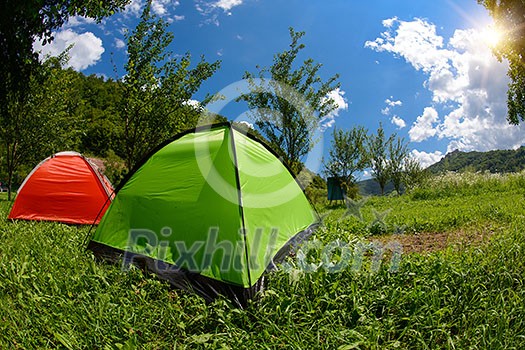calm relaxing camp tent near the beautiful river on sunny summer day