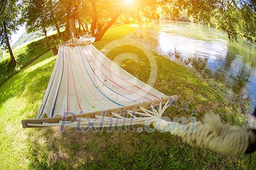 hammoc swing bed summer time in beautiful nature camp near river