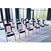 interior of big modern conference room with gifts and headphones on chairs for participants before starting a business seminar