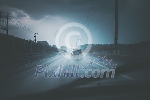 Cars on a highway at a rainy dusk (shallow DOF; color toned image) Cars on a highway at a rainy dusk (shallow DOF; color toned image)