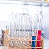 Lab worker's hands while at work at a research center in a lab, carrying out an experiment (shallow DOF; color toned image)