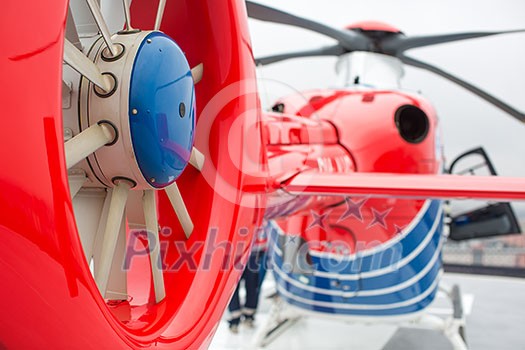 Modern medical helicopter on a hospital rooftop helipad from behind - shallow DOF
