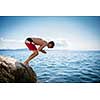 Young man having fun and taking a dive in the sea