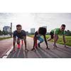 multiethnic group of young people on the jogging beautiful morning as the sun rises in the streets of the city