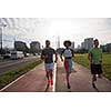multiethnic group of young people on the jogging beautiful morning as the sun rises in the streets of the city