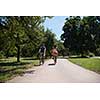 a young man and a beautiful African American girl enjoying a bike ride in nature on a sunny summer day