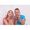 young romantic  couple in love  celebrating and blowing confetti decorations