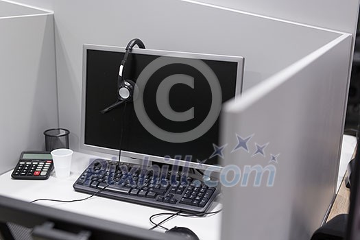 Computer and headset in empty call center office Computer and headset in empty call center office