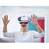 Smile happy woman getting experience using VR-headset glasses of virtual reality at home