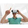 happy man getting experience using VR-headset glasses of virtual reality at home