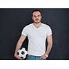 young handsome man playing with soccer ball isolated over grey background