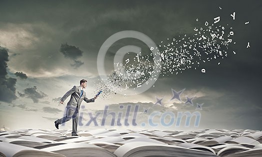 Young businessman running with book in hand
