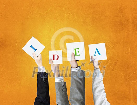 Group of business people holding in hands cards with letters Group of business people holding in hands cards with letters