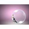 Young businesswoman trying to get out of soap bubble