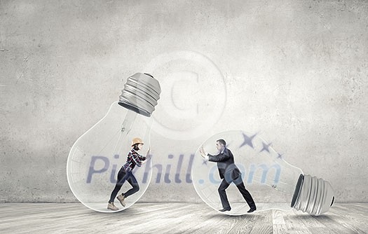 Businesswoman and businessman inside light bulb trying to get out