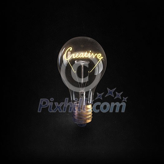 Glowing glass light bulb with creative word inside Glowing glass light bulb with creative word inside