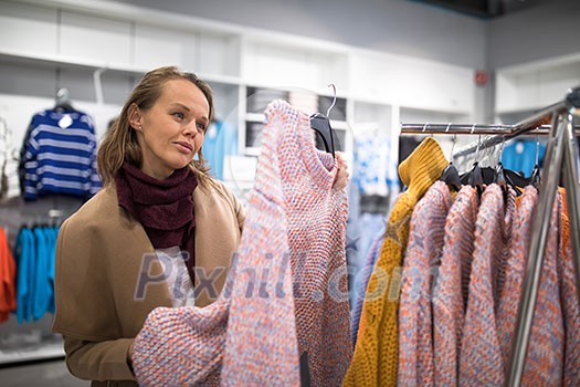 Young woman shipping in a clothing store for something fashionable Young woman shipping in a clothing store for something fashionable