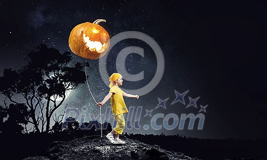 Small girl holding pumpkin balloon celebrating Halloween. Mixed media Small girl holding pumpkin balloon celebrating Halloween. Mixed media