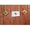 Envelopes hanging on rope on wooden background