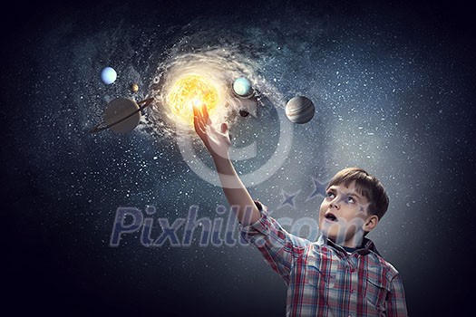 Cute boy of school age exploring space system. Mixed media