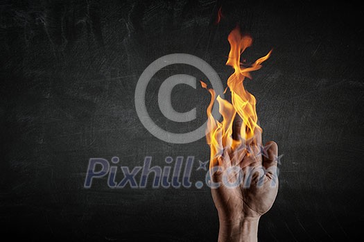 Young businessman holding fire flames in palm Young businessman holding fire flames in palm