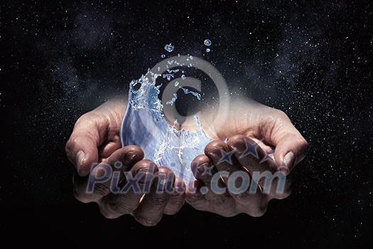 Close of person hands holding water splashes Close of person hands holding water splashes